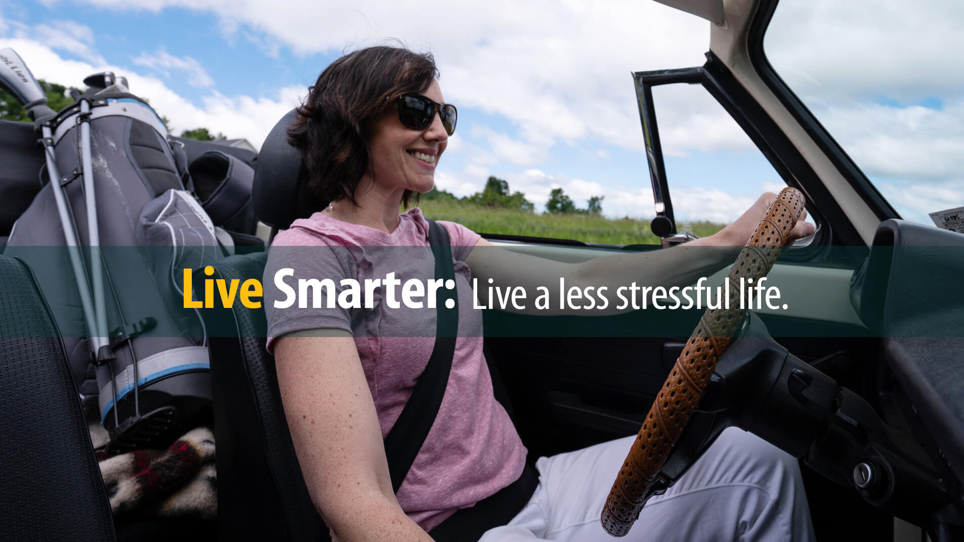 Smiling woman driving convertible is happy with a less stressful life managing her debt
